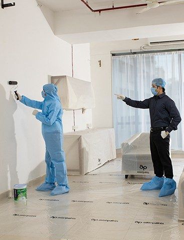 A painting supervisor wearing safety gear in the site.