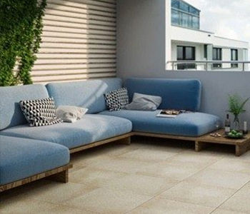 A terrace space with L-shaped sofa and cushions